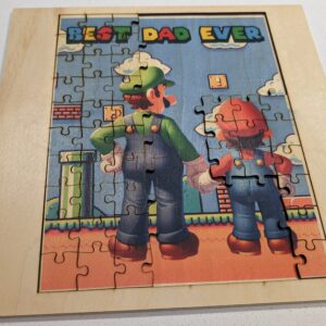 A jigsaw puzzle image of a father and child in iconic gaming attire, standing hand-in-hand against a vibrant game-themed backdrop, with ‘BEST DAD EVER’ written at the top.MARIO, Luigi