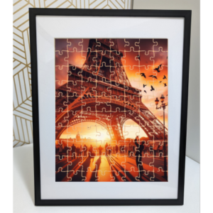 Jigsaw puzzle depicting the Eiffel Tower at sunset with silhouettes of people and flying birds.