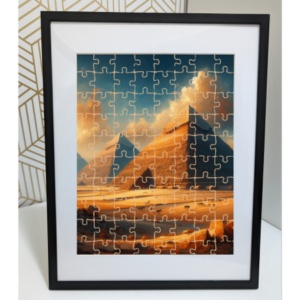 Completed jigsaw puzzle featuring a landscape with pyramids at sunset, framed and displayed against a patterned background.