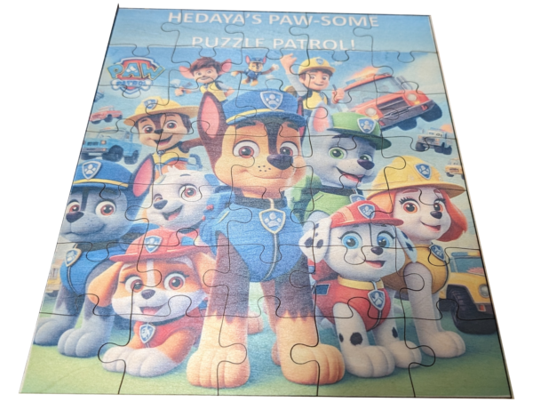 A completed custom wooden jigsaw puzzle featuring characters from the animated series Paw Patrol, with a focus on the central character, a brown and white police pup.